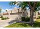 Beautiful home with a two-car garage, lush lawn, desert landscaping, and mature trees at 5445 E Mckellips Rd # 48, Mesa, AZ 85215