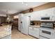Bright kitchen featuring white appliances, white cabinetry and granite countertops at 5445 E Mckellips Rd # 48, Mesa, AZ 85215
