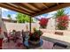 Private patio area with covered section, gravel, tile floor, flowers, and sitting area at 5445 E Mckellips Rd # 48, Mesa, AZ 85215