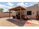 Covered patio featuring a sitting area, tile floor, and desert landscaping at 5445 E Mckellips Rd # 48, Mesa, AZ 85215