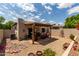 Private patio area with gravel, mature landscaping, and stone sitting area at 5445 E Mckellips Rd # 48, Mesa, AZ 85215