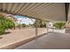 The covered back patio showcases the expansive backyard filled with desert landscaping at 5818 E Colby St, Mesa, AZ 85205