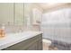 Updated bathroom featuring a modern single sink vanity and shower with modern fixtures at 5818 E Colby St, Mesa, AZ 85205