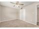 Neutral bedroom with wall-to-wall carpet, ceiling fan, ensuite access, and closet at 5818 E Colby St, Mesa, AZ 85205