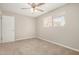 Neutral bedroom with natural lighting, neutral carpet and walls, and ceiling fan at 5818 E Colby St, Mesa, AZ 85205
