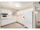 Functional kitchen featuring ample white cabinetry and modern appliances, tiled backsplash and light flooring at 5818 E Colby St, Mesa, AZ 85205