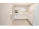 Well-lit kitchen showcasing white appliances, cabinets, and updated tiled countertops and flooring at 5818 E Colby St, Mesa, AZ 85205
