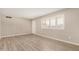 Bright, airy living room with modern laminate flooring, neutral walls, and large window with plantation shutters at 5818 E Colby St, Mesa, AZ 85205