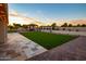 Enjoy outdoor living with a gazebo, mature trees, and a synthetic putting green in this landscaped backyard at 5922 W Michelle Dr, Glendale, AZ 85308
