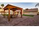 Entertain in this outdoor space featuring a gazebo, patio, putting green, and mature landscaping at 5922 W Michelle Dr, Glendale, AZ 85308