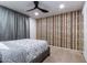Comfortable bedroom featuring carpet floors and a patterned accent wall at 5922 W Michelle Dr, Glendale, AZ 85308