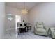 Inviting dining area featuring a glass table with bench, ceramic tile floor, and modern lighting at 5922 W Michelle Dr, Glendale, AZ 85308