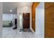 Elegant home foyer with custom lighting, ceramic tile flooring, and textured wall at 5922 W Michelle Dr, Glendale, AZ 85308