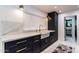 Modern kitchen featuring stainless steel appliances, navy cabinets, and white countertops at 5922 W Michelle Dr, Glendale, AZ 85308