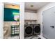 Laundry room featuring washer/dryer, vanity with sink, and stylish decor at 5922 W Michelle Dr, Glendale, AZ 85308