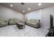 Bright living room featuring sleek tile floors and comfortable seating arrangements at 5922 W Michelle Dr, Glendale, AZ 85308