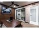 Bright office space with an organized closet and a view to the backyard at 5922 W Michelle Dr, Glendale, AZ 85308