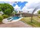 Aerial view of backyard featuring a refreshing pool, diving board, lush lawn, and mature trees at 5926 S Newberry Rd, Tempe, AZ 85283