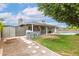 Expansive backyard view showcasing the patio, lush lawn, gravel path, and sparkling pool at 5926 S Newberry Rd, Tempe, AZ 85283