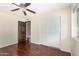 Bedroom featuring wood floors, closet, and view to the ensuite bathroom at 5926 S Newberry Rd, Tempe, AZ 85283