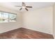 Comfortable bedroom with hardwood floors and a large window for natural light at 5926 S Newberry Rd, Tempe, AZ 85283