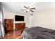 Bedroom featuring hardwood floors, a ceiling fan, and dresser at 5926 S Newberry Rd, Tempe, AZ 85283