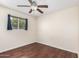 Clean bedroom with dark wood floors and ample natural light from the large window at 5926 S Newberry Rd, Tempe, AZ 85283