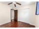 Well-lit bedroom featuring modern sliding closet doors and wood floor at 5926 S Newberry Rd, Tempe, AZ 85283