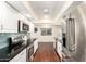 Bright kitchen with stainless steel appliances, dark counter tops, and wood flooring at 5926 S Newberry Rd, Tempe, AZ 85283