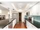 Modern kitchen featuring dark countertops, stainless steel appliances, and wood flooring at 5926 S Newberry Rd, Tempe, AZ 85283