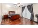 Main bedroom with hardwood floors, ceiling fan, and a door to the backyard at 5926 S Newberry Rd, Tempe, AZ 85283