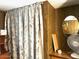 Small bedroom nook with a decorative curtain and a utilitarian desk and fan at 5933 E Main St # 114, Mesa, AZ 85206