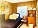 Compact bedroom with a cozy bed, natural light, and basic furniture arrangement for simple living at 5933 E Main St # 114, Mesa, AZ 85206