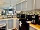 This kitchen features gray cabinets, mosaic backsplash, and stainless steel appliances at 5933 E Main St # 114, Mesa, AZ 85206