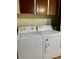 This laundry room features a white Amana washer and dryer at 5933 E Main St # 114, Mesa, AZ 85206