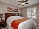 Comfortable bedroom with a large bed, ceiling fan, and shuttered windows at 5995 N 78Th St # 1047, Scottsdale, AZ 85250