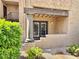 Exterior view of a townhome with column accents, shutters, and manicured landscaping at 5995 N 78Th St # 1047, Scottsdale, AZ 85250