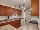 Efficient kitchen featuring wood cabinets, stainless sink, modern appliances, and tile backsplash at 5995 N 78Th St # 1047, Scottsdale, AZ 85250