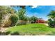 Spacious backyard featuring a red-roofed gazebo and lush green lawn at 6601 W Montego Ln, Glendale, AZ 85306