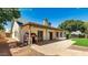 Exterior view of a home showcasing a spacious backyard, covered patio, and lush greenery at 6601 W Montego Ln, Glendale, AZ 85306