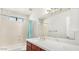 Updated bathroom featuring a large mirror, and shower-over-tub combo at 6601 W Montego Ln, Glendale, AZ 85306