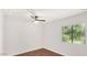 Well-lit bedroom featuring wood floors, a modern ceiling fan, and a bright window at 6601 W Montego Ln, Glendale, AZ 85306