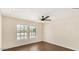 Well-lit bedroom featuring wood floors, a modern ceiling fan, and bright double windows at 6601 W Montego Ln, Glendale, AZ 85306