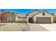 Charming single-story home featuring a two-car garage and low-maintenance desert landscaping in front at 6601 W Montego Ln, Glendale, AZ 85306