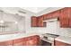 Well-lit kitchen featuring modern appliances, granite countertops, and tile backsplash at 6601 W Montego Ln, Glendale, AZ 85306