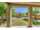Covered patio providing tranquil views of a well-manicured backyard with a well-kept lawn at 6811 W Darrel Rd, Laveen, AZ 85339