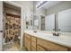 This bathroom offers a double sink vanity and a shower with patterned curtain at 6811 W Darrel Rd, Laveen, AZ 85339