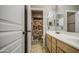 Bathroom offers a double sink vanity, mirrors, and a doorway to a shower at 6811 W Darrel Rd, Laveen, AZ 85339