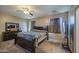 Cozy bedroom features a ceiling fan, neutral walls, and a dark wood dresser and matching furniture at 6811 W Darrel Rd, Laveen, AZ 85339