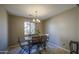Dining room with wood table and chairs, decorative chandelier and large window at 6811 W Darrel Rd, Laveen, AZ 85339